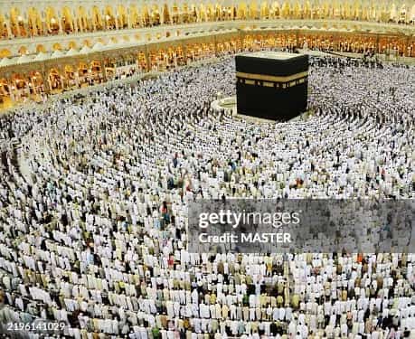 Muslim pilgrims performing Tawaf around the Kaaba in Mecca during the best time for Umrah season with clear skies.